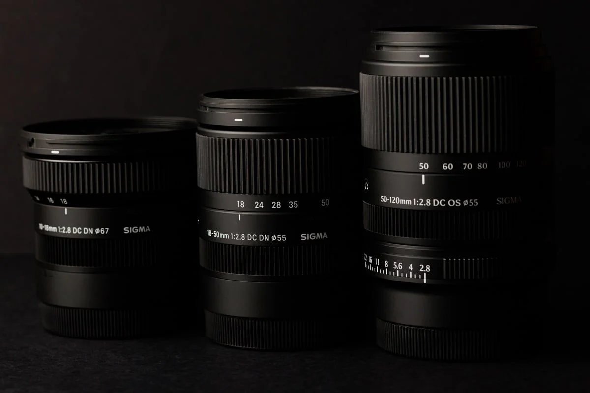 Leaked photo of a Sigma 50-120mm F2.8 DC OS lens beside two smaller Sigma zooms